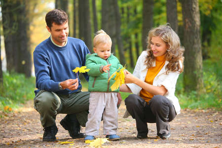 family with child in autumnal woodの写真素材