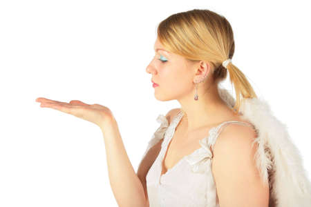 girl in angel's costume looks on open palmの写真素材