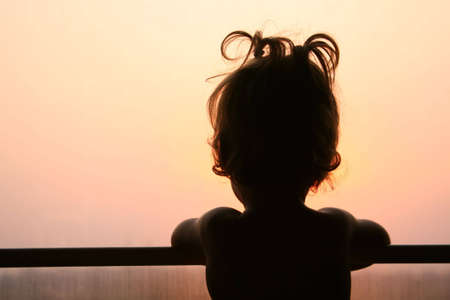 Silhouette of child in window of trainの写真素材
