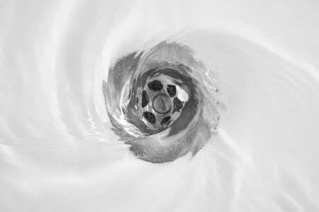 water flow into drain in bathの写真素材