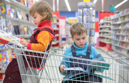 Children in bookshop, focus on boyの写真素材