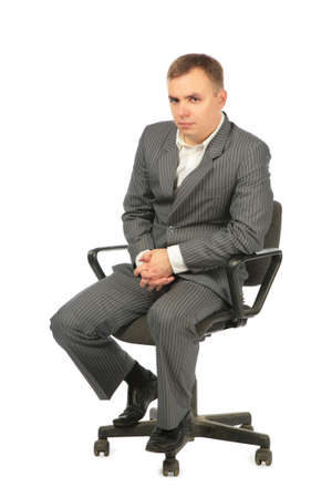 serious businessman sits on chairの写真素材