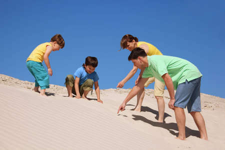 family plays on the beach, found somethingの写真素材
