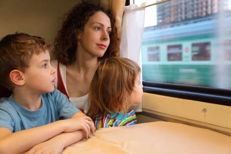 mother and children  look in train`s windowの写真素材