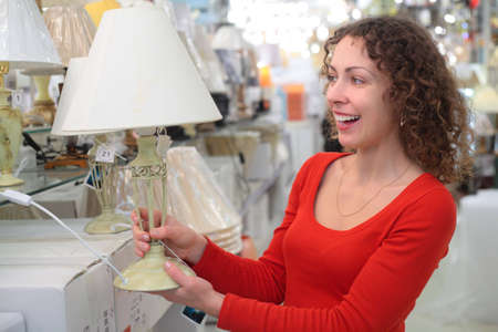 young woman in shop of house technicswith table lampの写真素材