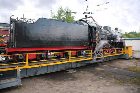 Steam locomotive on rotating tableの写真素材