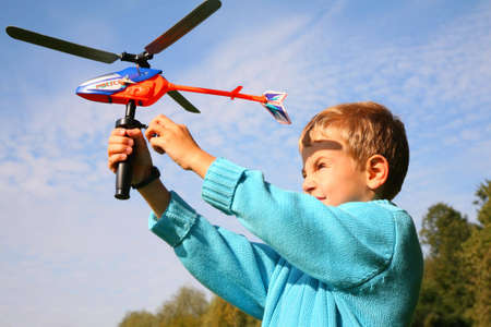 boy starts toy helicopterの写真素材