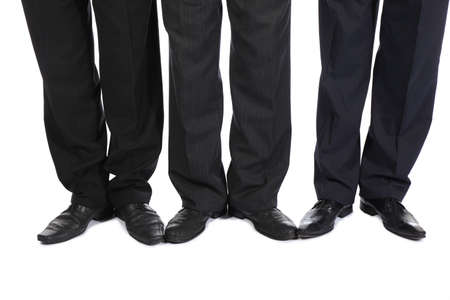 Legs of three businessmenの写真素材