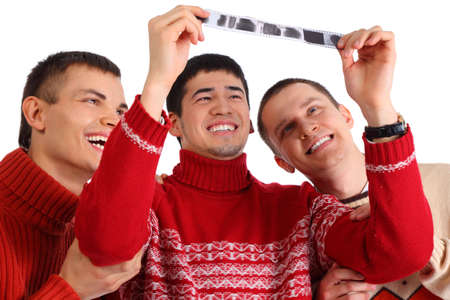 Three friends look at filmの写真素材