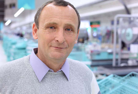 closeup elderly man in shop with empty countersの写真素材