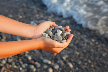 Handful of stones in handsの写真素材