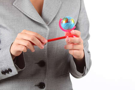 woman's hands with small globe pencil sharpenerの写真素材