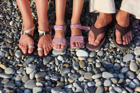 lot of feet on the stones. family with girlの写真素材