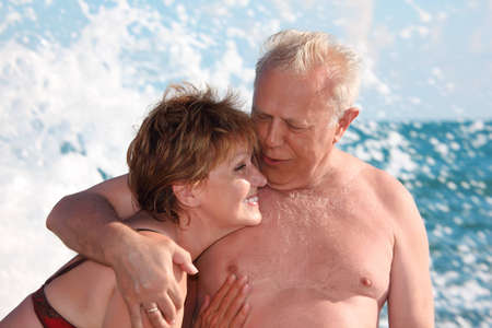portrait of aged  pair in sea surfの写真素材