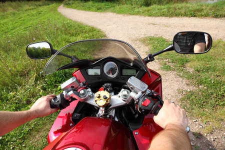 hands of motorcyclist  on country roadの写真素材