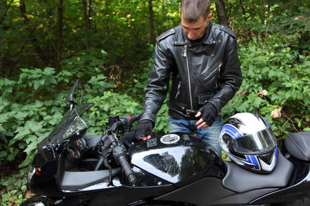 motorcyclist and his bike in forestの写真素材