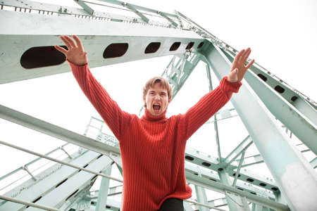 guy is screaming and jumping from the bridgeの写真素材