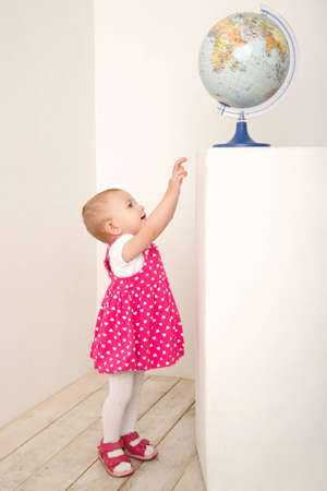 Portrait of little girl with globeの写真素材