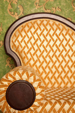 Fragment of sofa against green wall. Interior in retro style. Vertical format.の写真素材