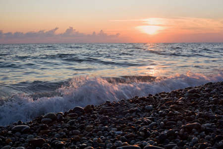 Sea coast with waves on sunset, Stony beachの写真素材