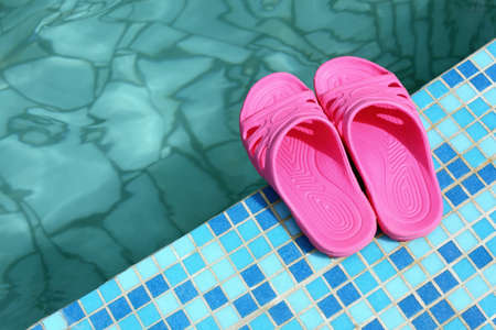 Beach slippers on pool side の写真素材