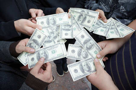 five teens staying with funs of dollars in their hands close by