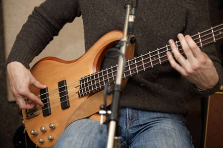 guitar player body near microphoneの写真素材