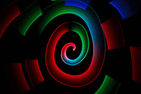 Abstract multicolored glowing in spiral pattern on black background.