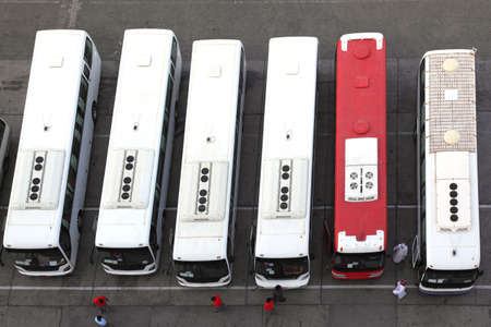 regular buses on station and drivers in uniform view from aboveの写真素材
