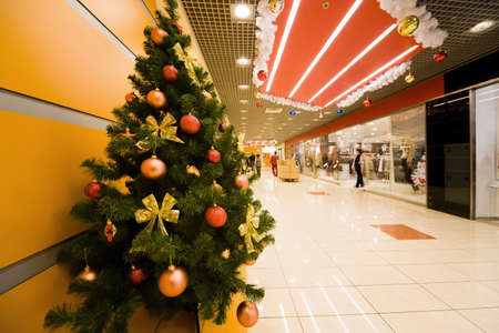 Fur-tree densely covered by Christmas ornaments in shopping centre corridorのeditorial素材