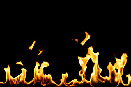 yellow fire with flame tongues isolated on black