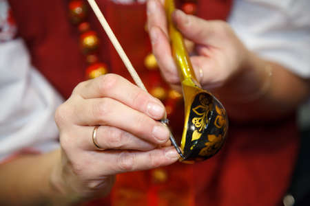 Of painting designs wooden spoons. Khokhloma painting - Russian national crafts. Focus on the brush.のeditorial素材