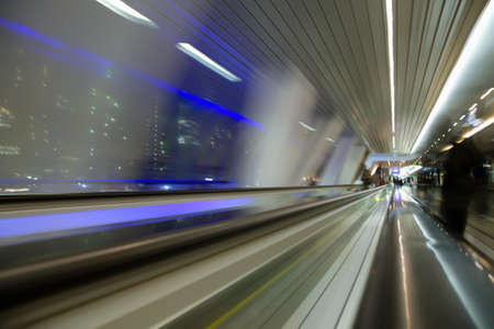 blured abstract view from window in long corridor in modern building on night city