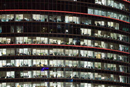 modern office building with big windows at night, in windows light shines
のeditorial素材