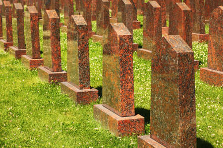 Rows of obelisks of red granite at the military memorial.