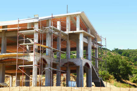 Sceleton of new suburb cottage house with front staircase on hill