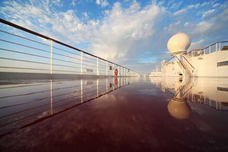 deck of cruise ship shining by morning sun. reflection in deck