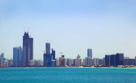 The view from the sea of the buildings and skyscrapers in Abu Dhabi downtown.のeditorial素材