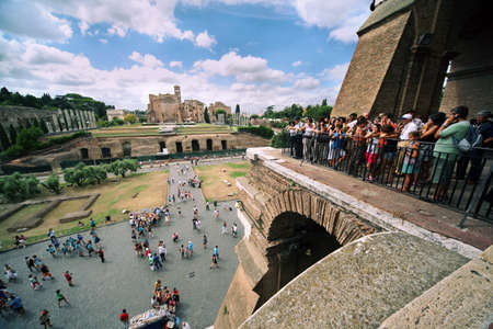 ROME - AUGUST 5:Tourists on Coliseum in front of ruins of Temple of Venus and Rome, the largest religious building of ancient Rome in 135 AD, August 5, 2010 in Rome, Italy.のeditorial素材