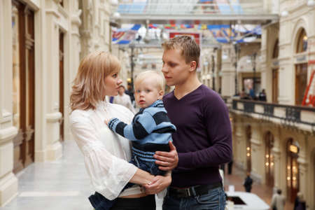 Family of three persons, Father, mother and their son together. Mother keeps child in her arms.のeditorial素材