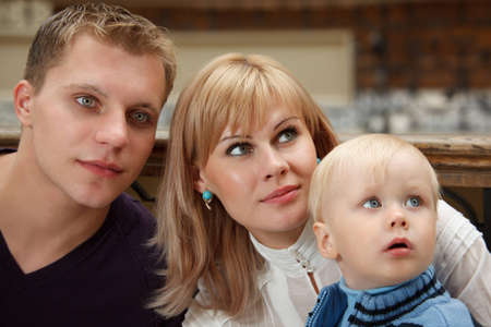 Family of three people close up. Look to right.の写真素材