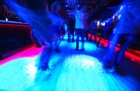 Legs of energy dancing people on the dance floor at night clubのeditorial素材