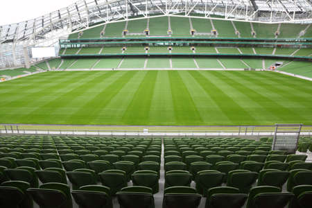 Rows of green seats in an empty stadium. Focus on front seatsのeditorial素材