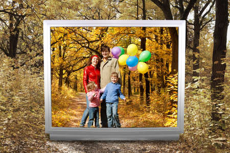family of four with balloons and Footpath among yellowed trees in autumnal park in unreal tv screen...