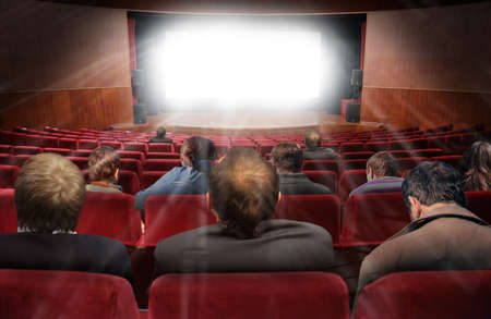 spectators in hall of cinema with movie collageの写真素材