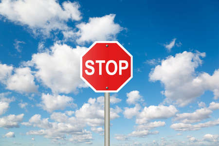 STOP sign on White, fluffy clouds in blue sky collageの写真素材