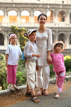 young mother, little son and two daughters are near Colosseum in Rome, focus on boyの写真素材