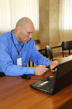 MOSCOW - FEBRUARY 19: Nikolay Valuev sits at table and looks at phone at World Cup 2011 KUDO, on...