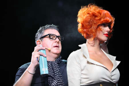 MOSCOW - SEPTEMBER 6: Tim Hartley sprays hairspray on fire hair of model at Davines Hair Show 2010, on September 6, 2010 in Moscow, Russia. のeditorial素材