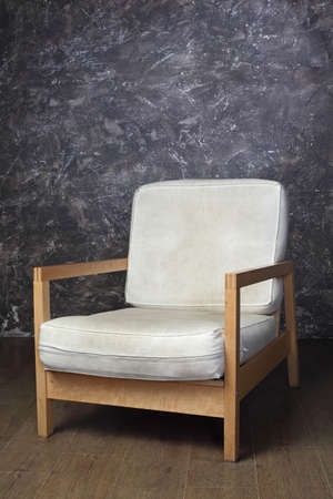 white chair in studio of photographer, brown background, side viewの写真素材